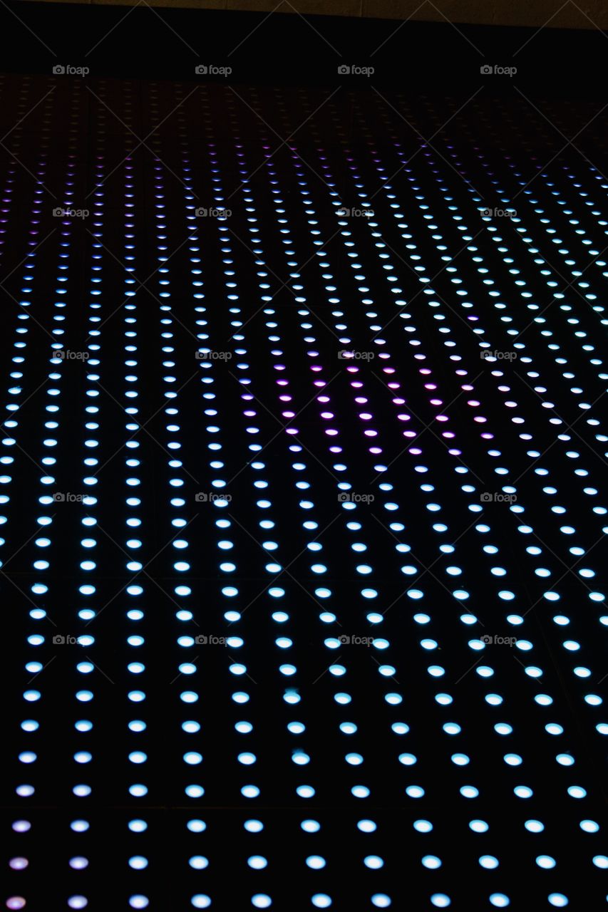 Angular view of multi-colored lighted circles on black background