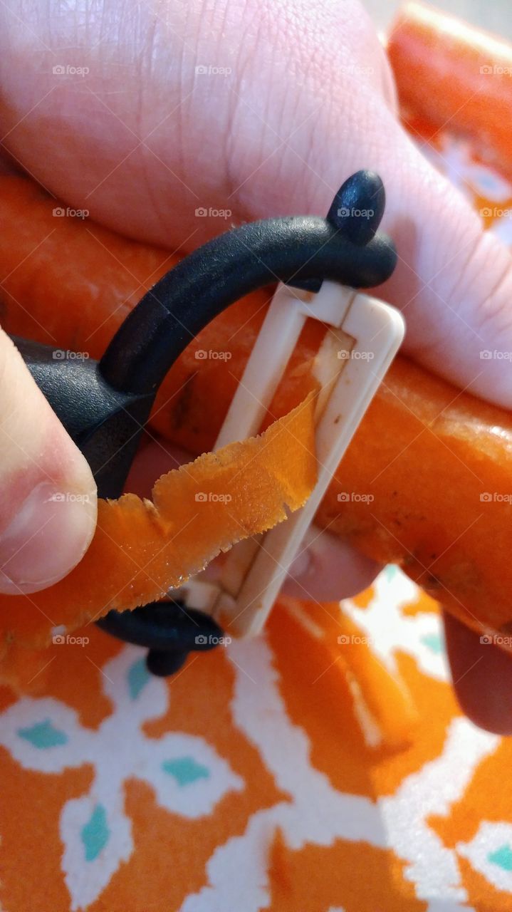Peeling carrot close up