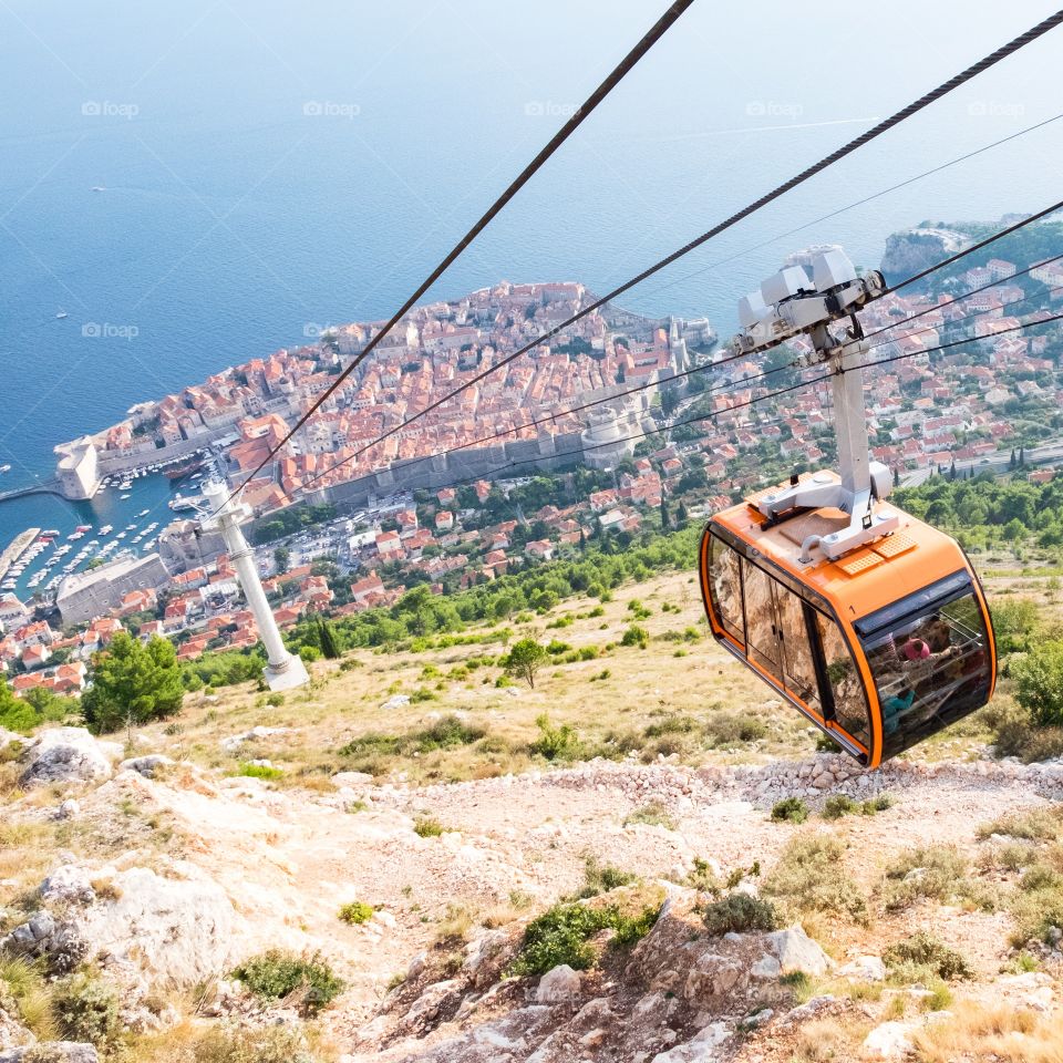 A cable car ascends above Dubrovnik's Old Town in Croatia.