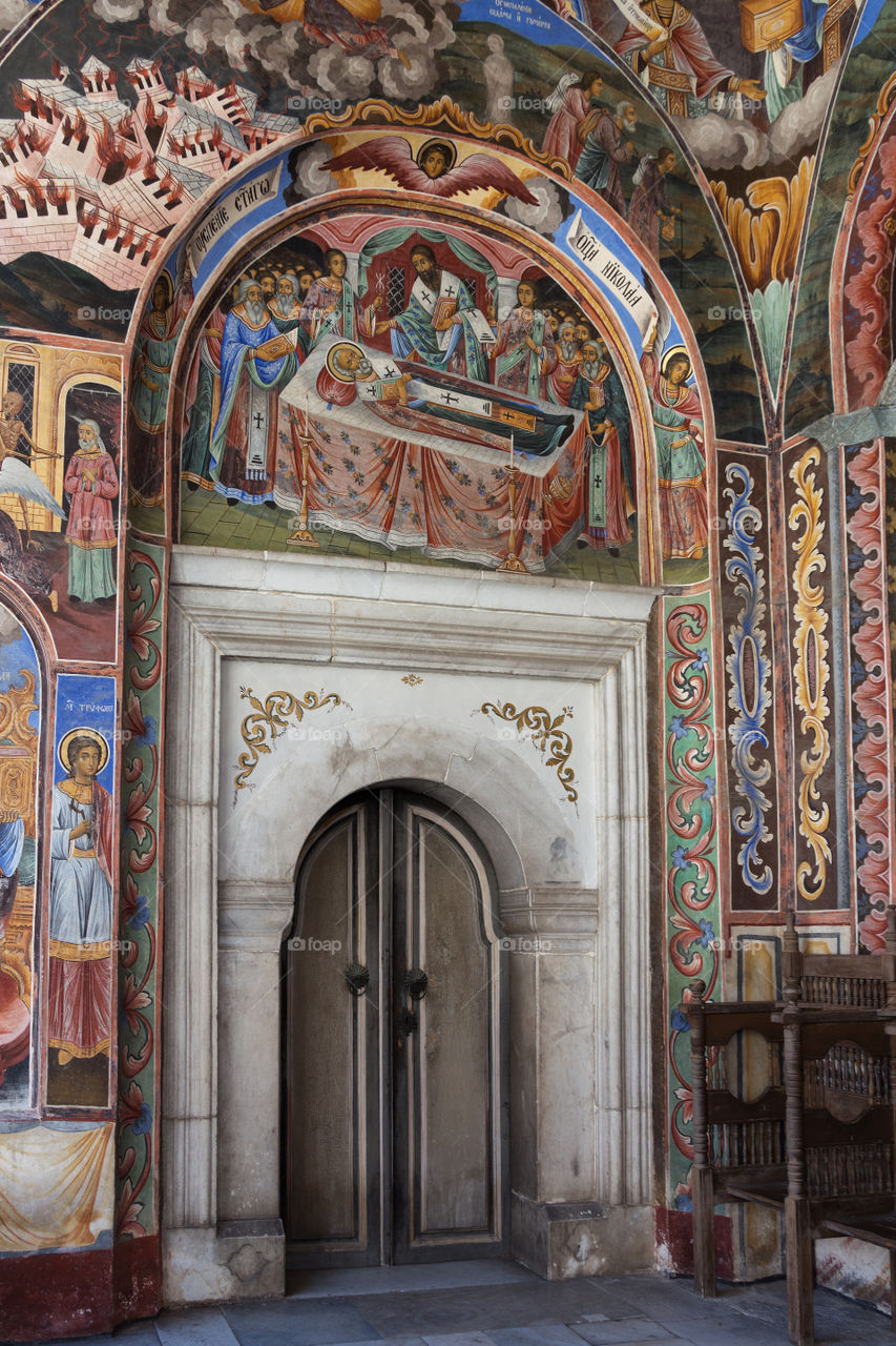Rila Monastery in Bulgaria. Door and vivid frescos in the church at the Rila Monastery - Unesco World Heritage