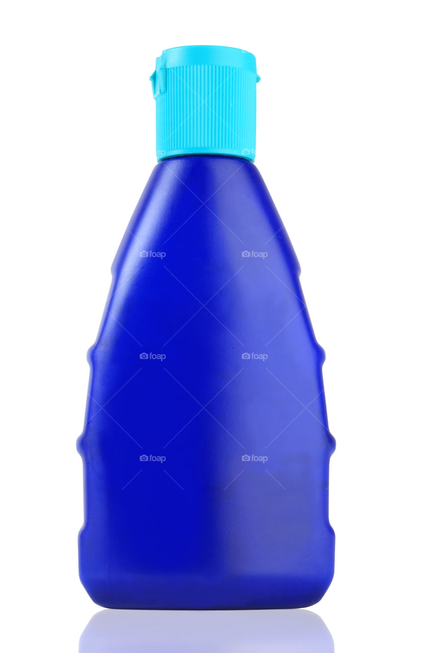 Blank blue bottle isolated on white background