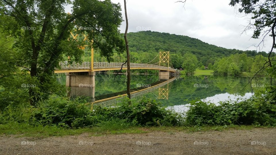 One Lane, Two Way Bridge. Side view of single Lane bridge and refection on lake, Holiday Island, Arkansas