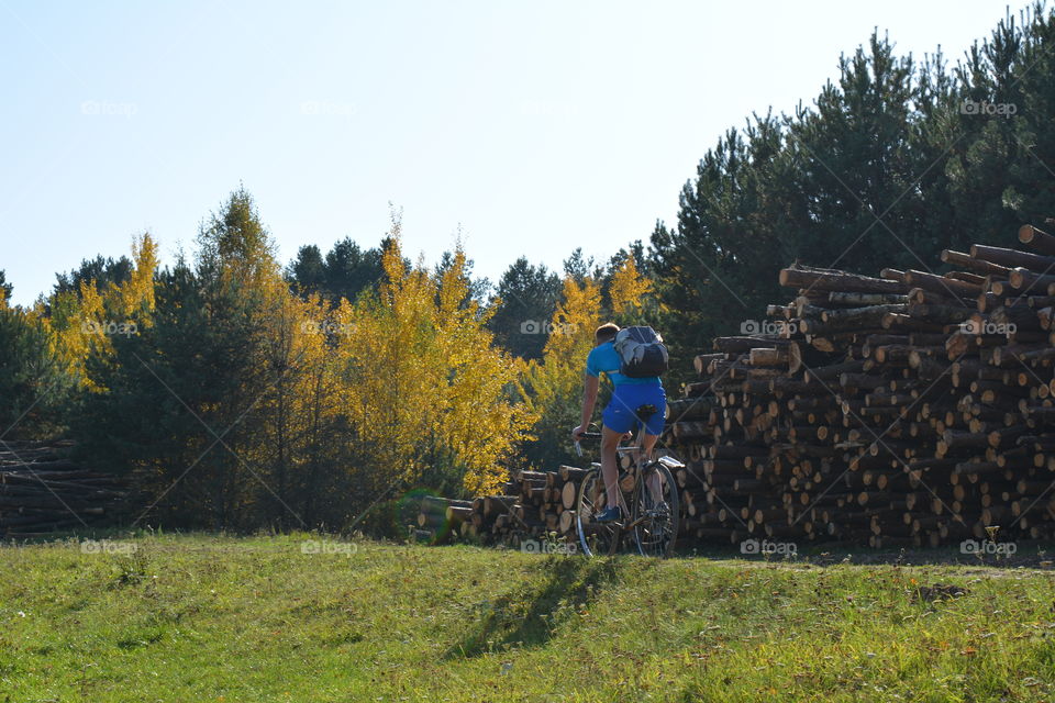 men riding on a bike autumn beautiful landscape