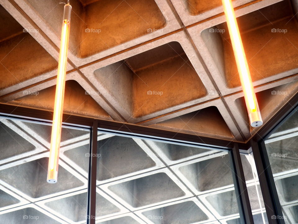 colorful, grey and orange ceiling of the London Museum with light and glass.