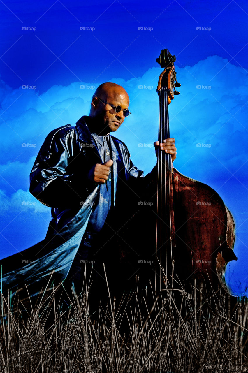 Man with upright base. Image of a man in a field with upright base