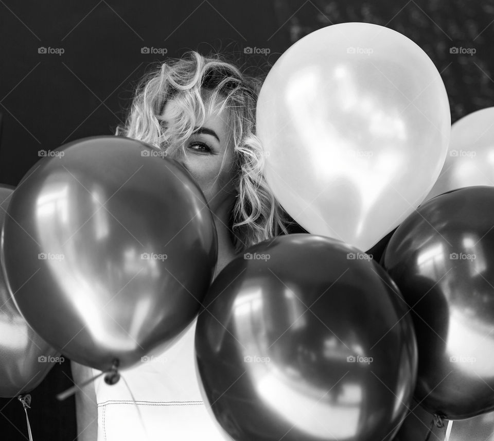 Happy sexy blond girl. Birthday girl. Girl walk at street with balloons 