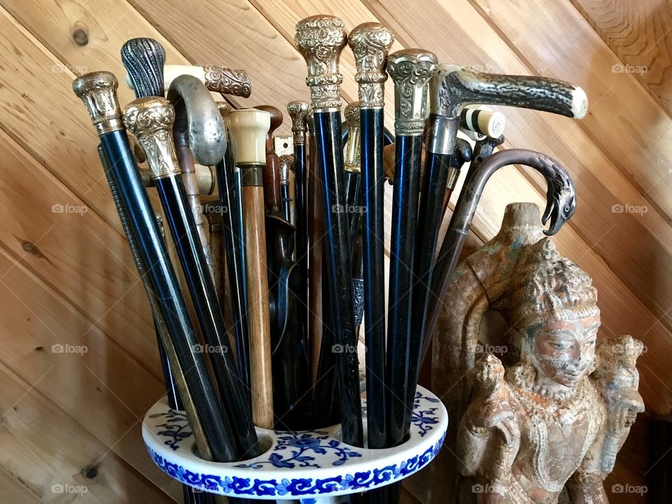 Vintage walking canes in a large ceramic container 