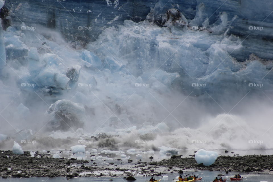 Glacier calving in front of kayakers!