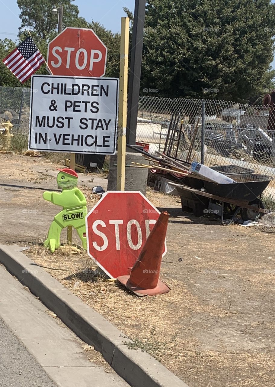 Stop sign at the garbage dump - warning sign for children and pets to stay in the vehicle. America, USA 