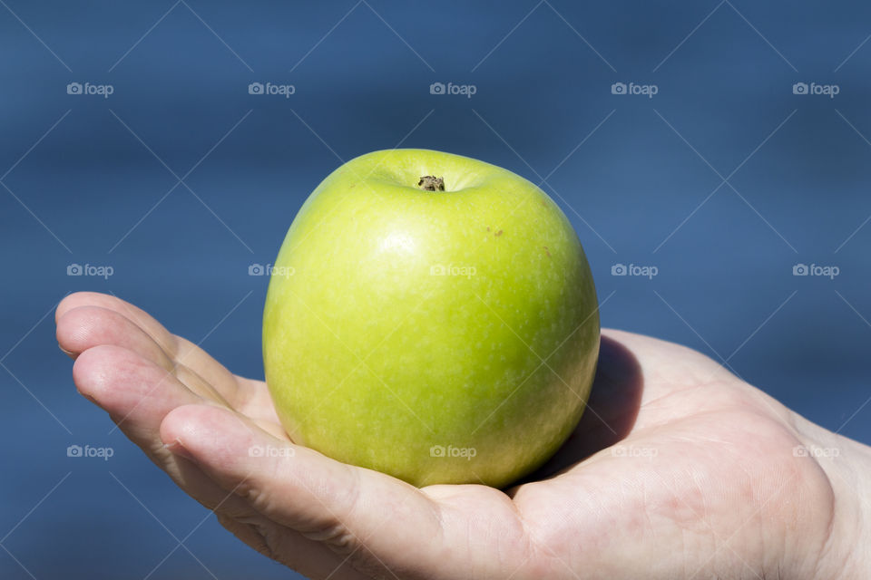 Green apple on hand