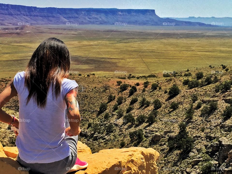 Woman looks the desert landscape 