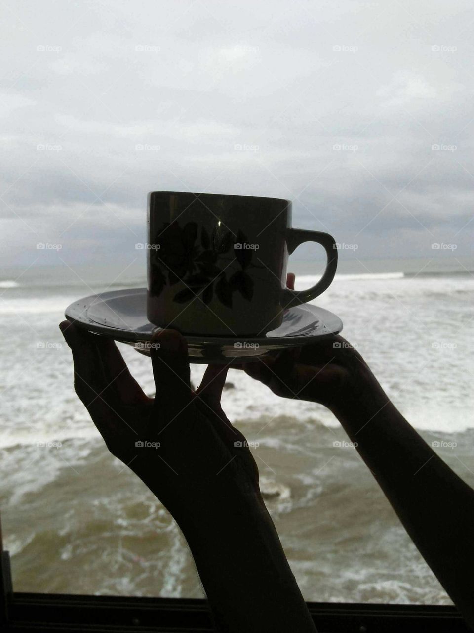 Beautiful cup of coffee on hands.