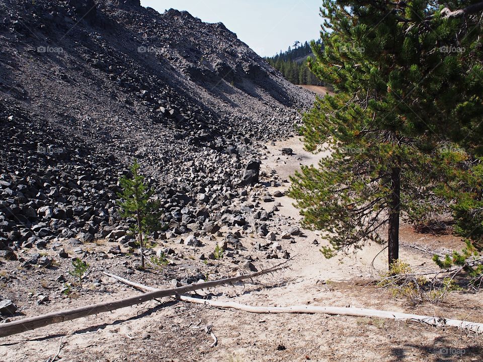 Textured Obsidian and hardened lava rock on a sunny fall day at the Big Obsidian Flow in the Newberry National Volcanic Monument in Central Oregon. 