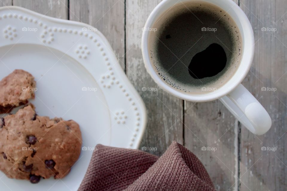 Flat lay of a “Giant Breakfast Cookie” and coffee, white stoneware and a brown fabric napkin on a weathered, wooden surface

Yum! 🍪☕️😋