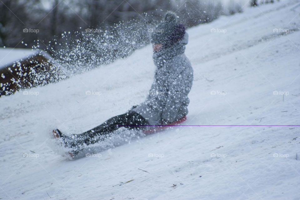 girl sledding down the mountain