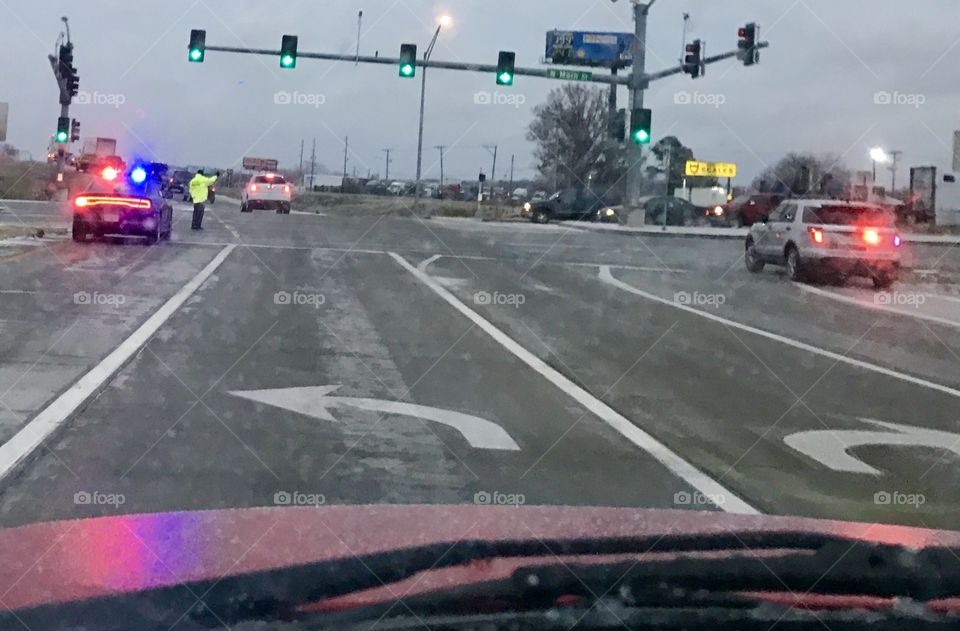 Police, Emergency Responders, Directing Traffic, Exit, Police Car, Lights and Sirens, a traffic Accident, high visibility, red, blue, flashing, traffic lights, green, light, ice, snow, weather, road, bridge, highway, intersection, arrows, lines, pavement, wet, slick, traffic, jam, reflection, purple