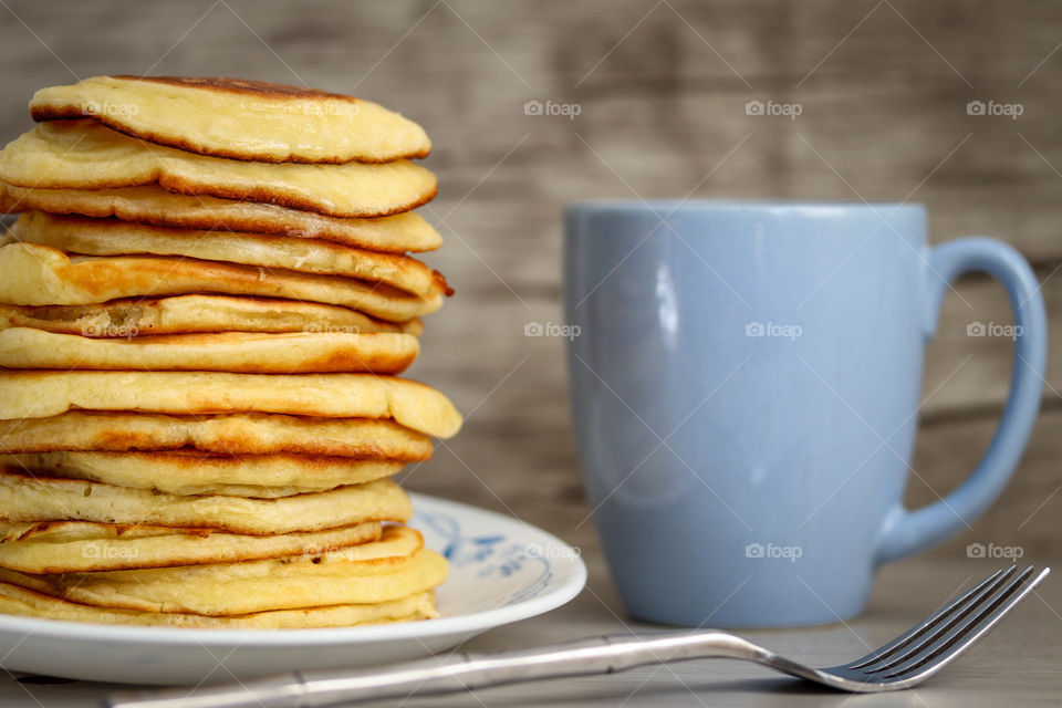 Pile of freshly made golden pancakes on a plate