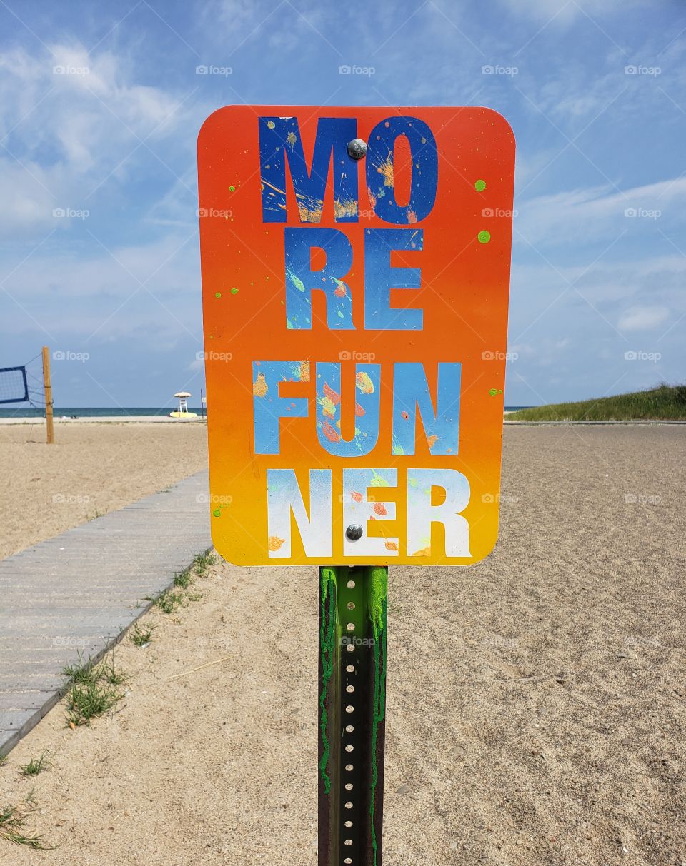 a sign at the beach saying have fun