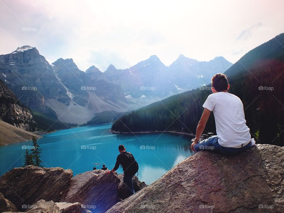 Me looking out at this amazing view of the mountains and lake at Moraine Lake, Canada
