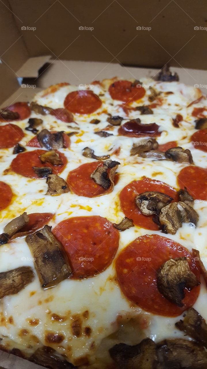 Pizza delivery cheese, pepperoni and mushrooms.