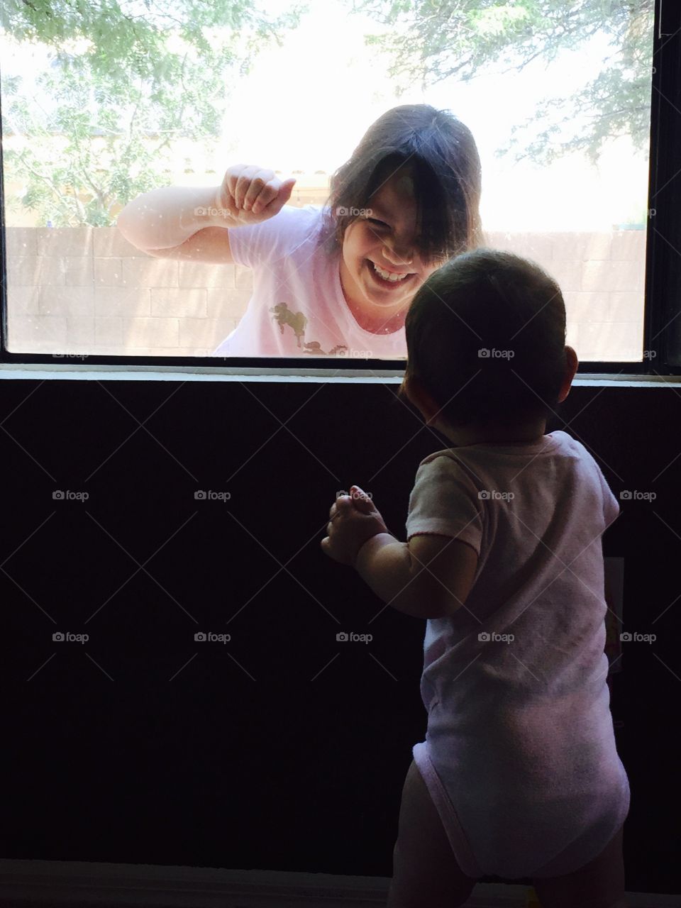 Sisters across the windowpane