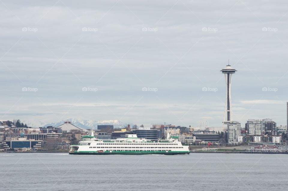 Space Needle and ferry boat. The Seattle Space Needle and skyline with a Washington State Ferry in the foreground.