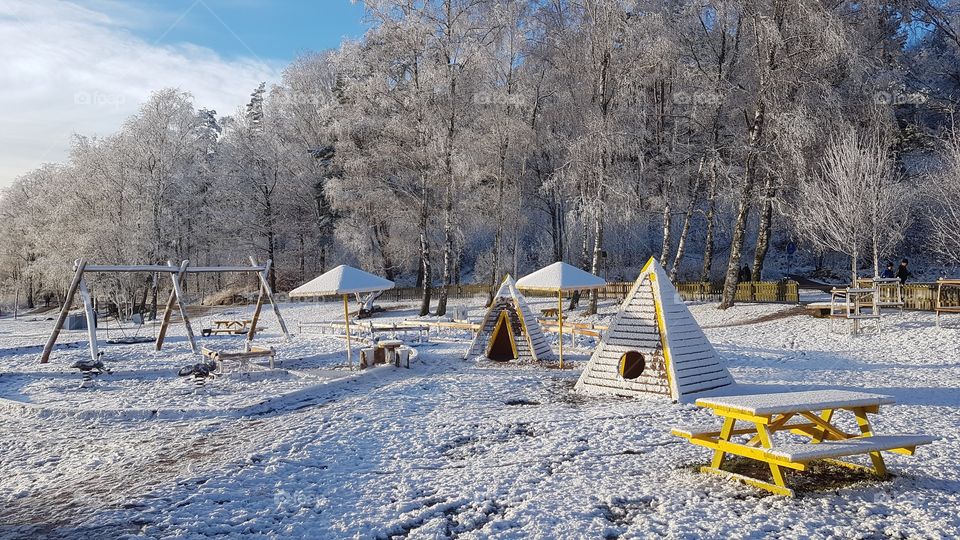Children’s playground in beautiful winter landscape in snow - lekplats i vackert vinterlandskap 