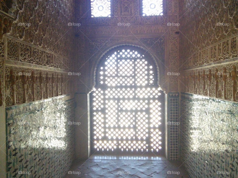 Dazzling light through morish window in Alhambra, Nazaríes palace. Celosía.