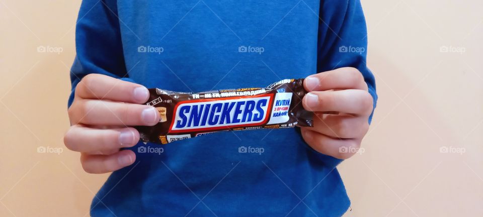 boy holding snickers