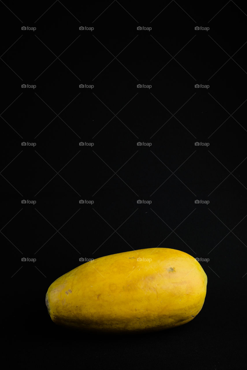 Papaya on black background . Tropical fruit