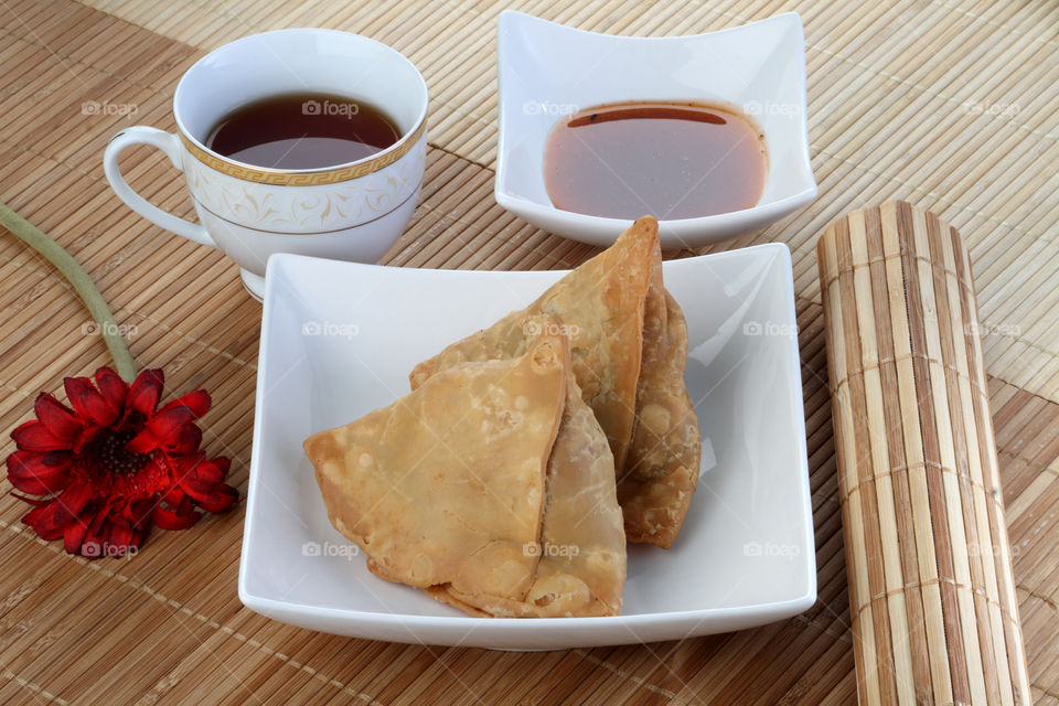 Indian food samosa with tea and chutney