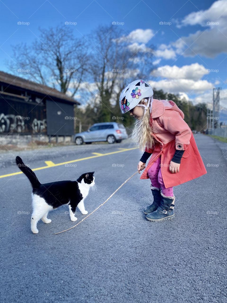 girl playing with a cat