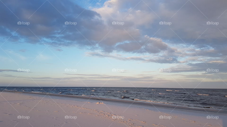 Pink-colored sand of a beach in sunset at Rømø, Denmark.