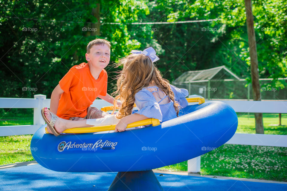 Boy and Girl Playing at a Playground 