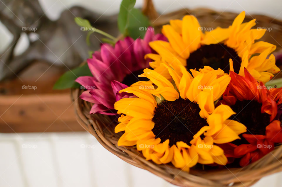 Basket of sunflowers in home tranquility health and wellness tranquil scene with Buddha statue in background 