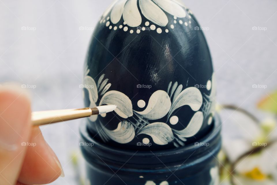 Painting a wooden egg