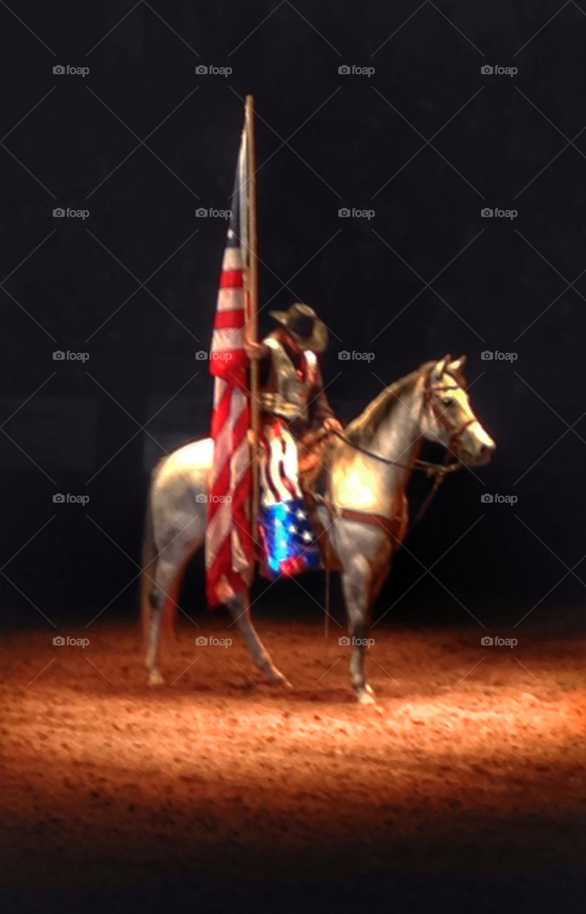 Prayerfully bow. Woman bowing head in prayer while holding American flag