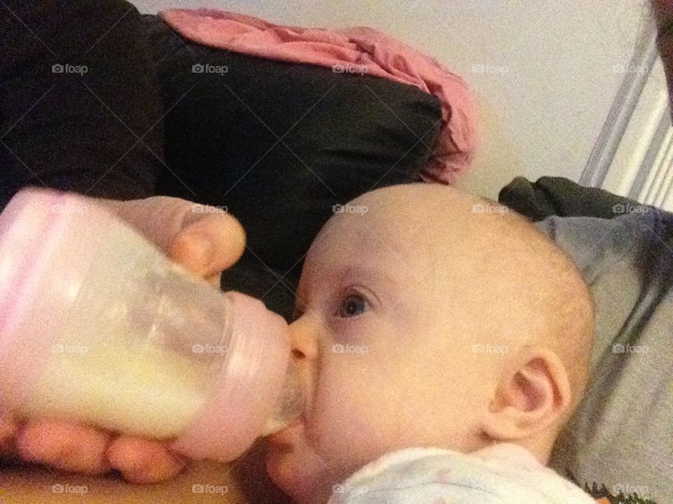 Baby with Down syndrome drinking bottle
