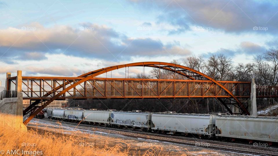 Train going under bridge