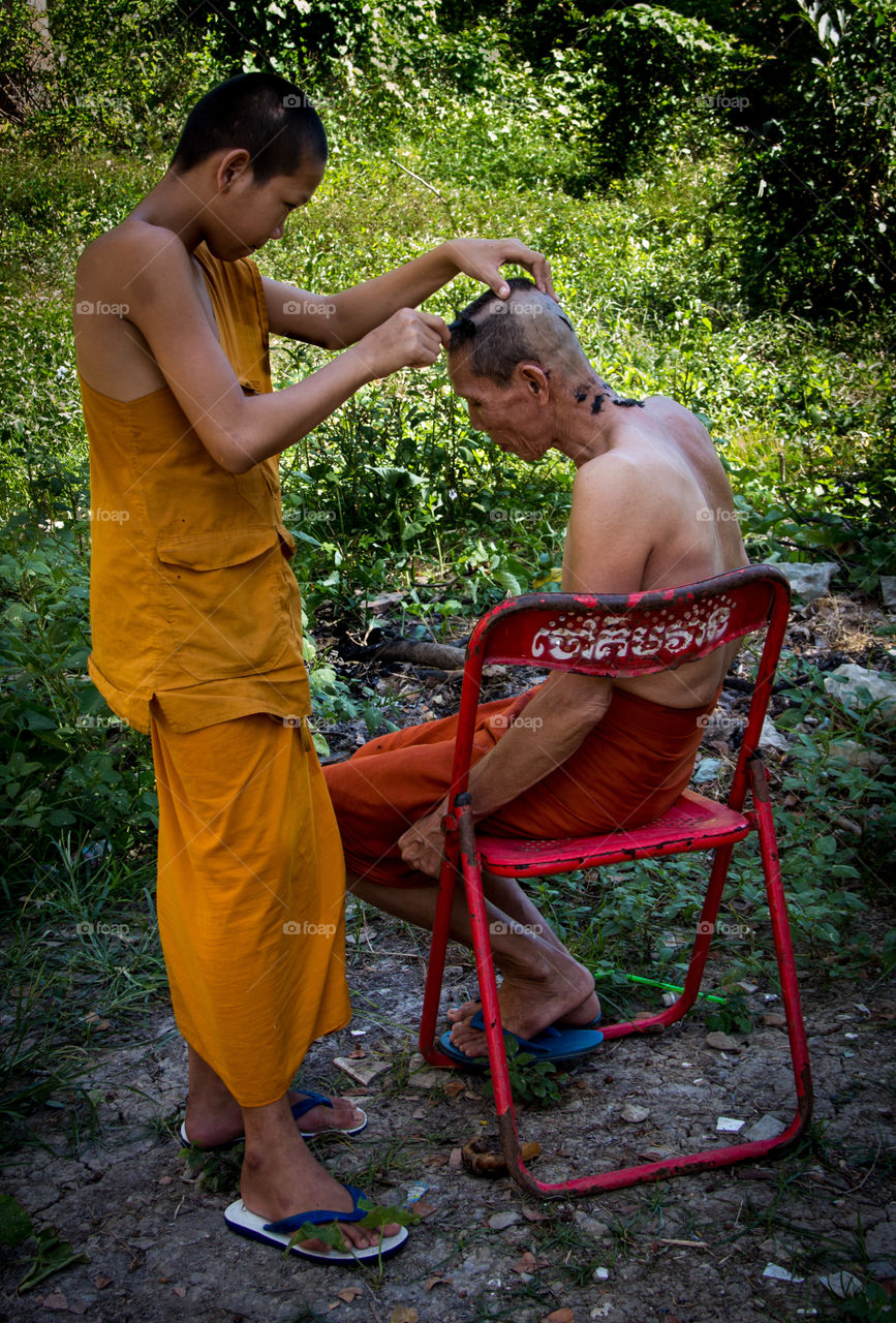 Intimate portrait - Young monk shaving a monk's head