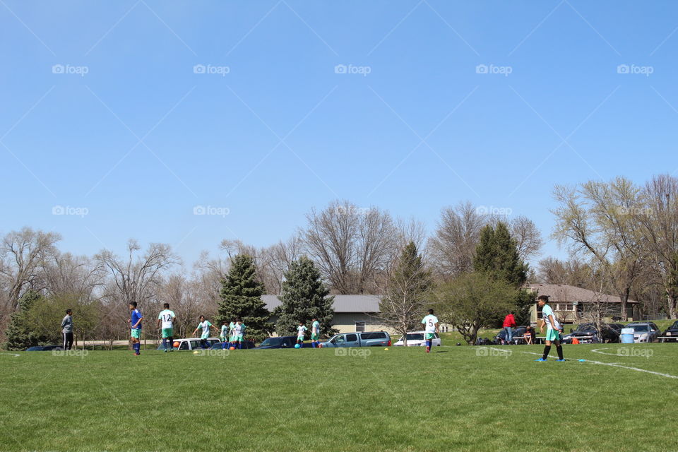 Kids playing soccer in a beautiful spring day 