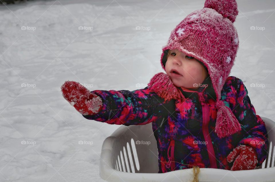 Cute little girl wearing worm clothing in winter