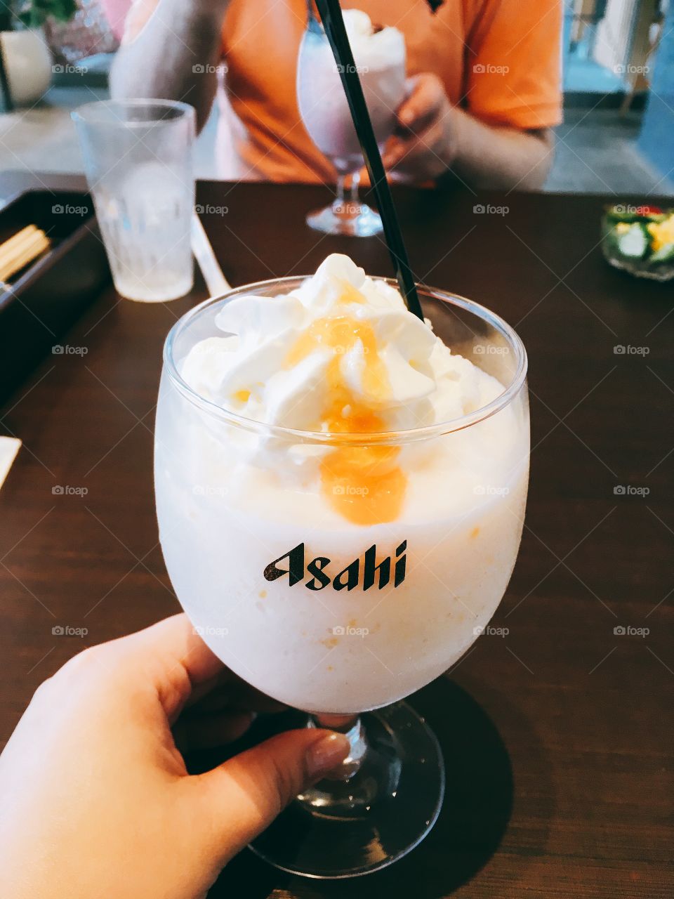 White peach smoothie in an Asahi glass. 