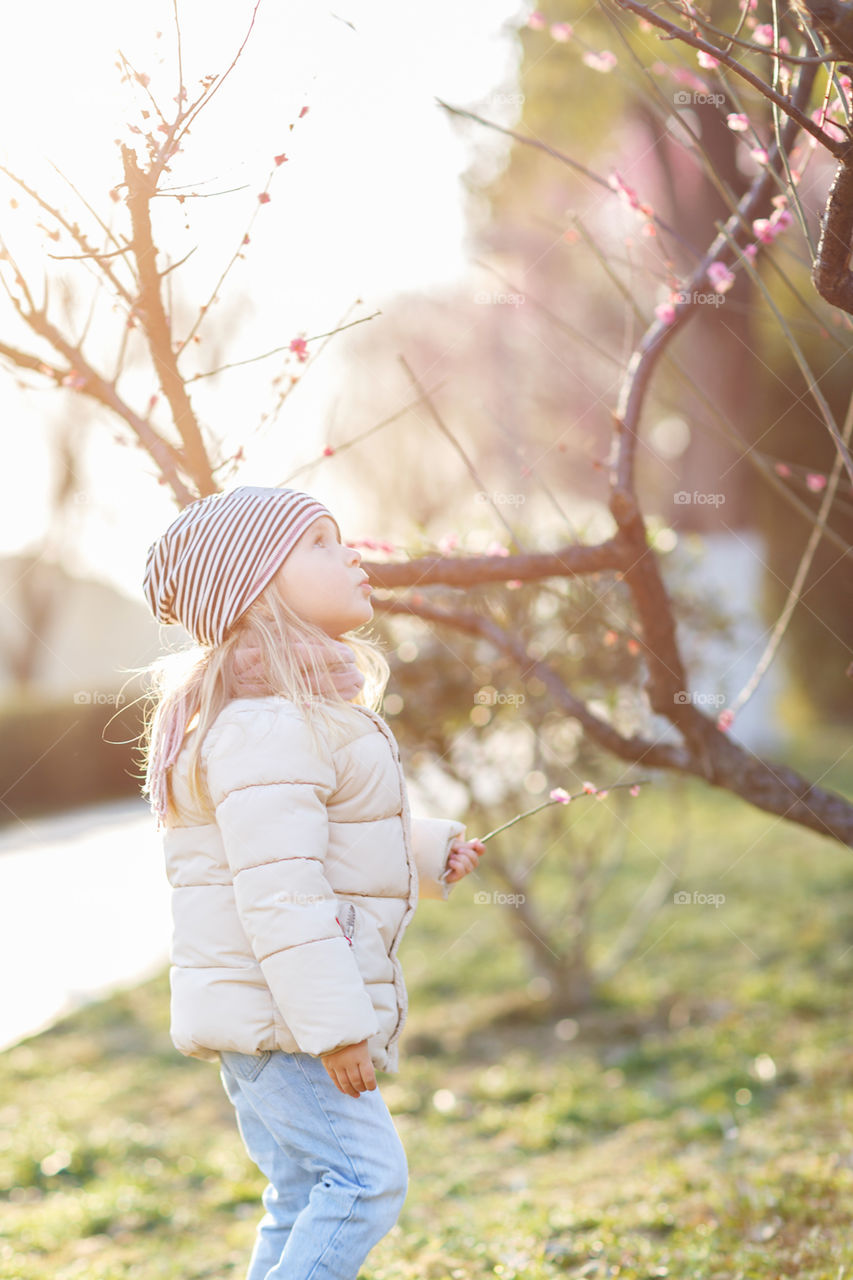 Little girl with blonde hair outdoor 