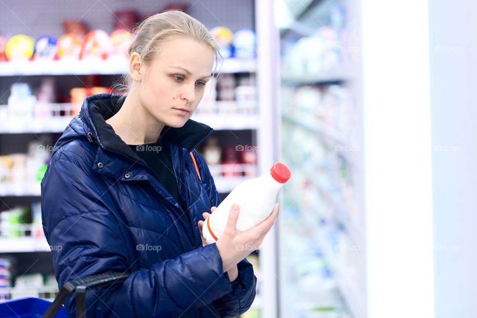 Shop. girl in shop chooses milk