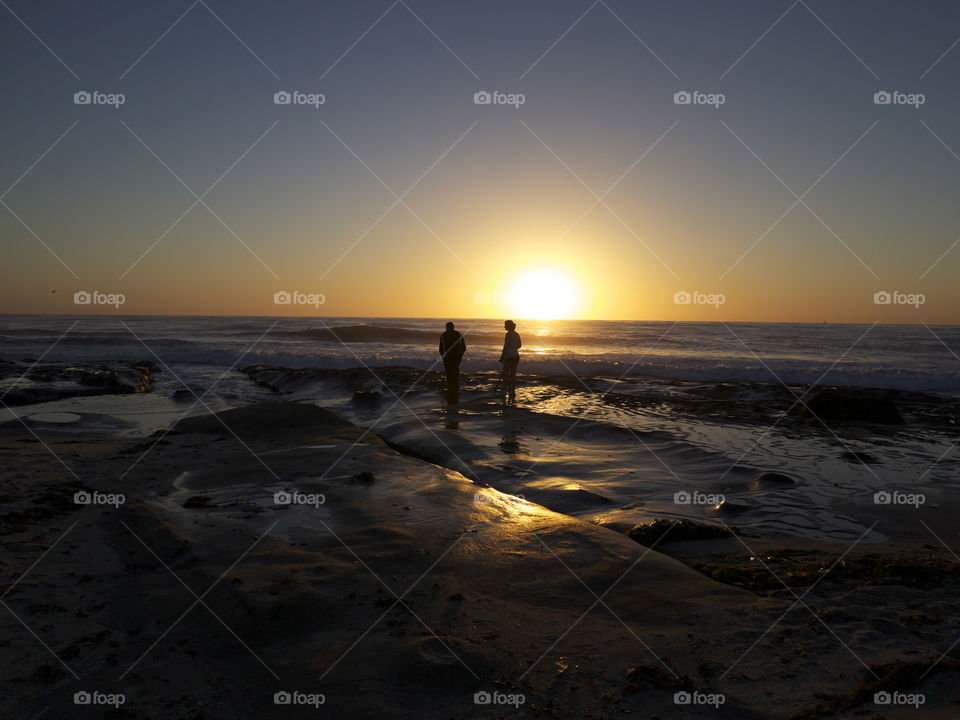 Silhouette of people standing during sunset