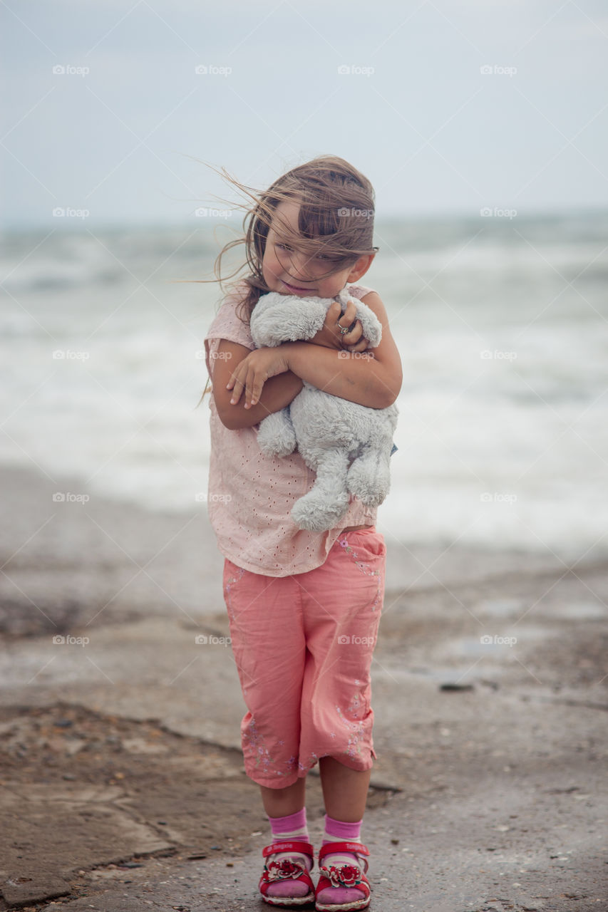 Girl portrait near sea a windy day