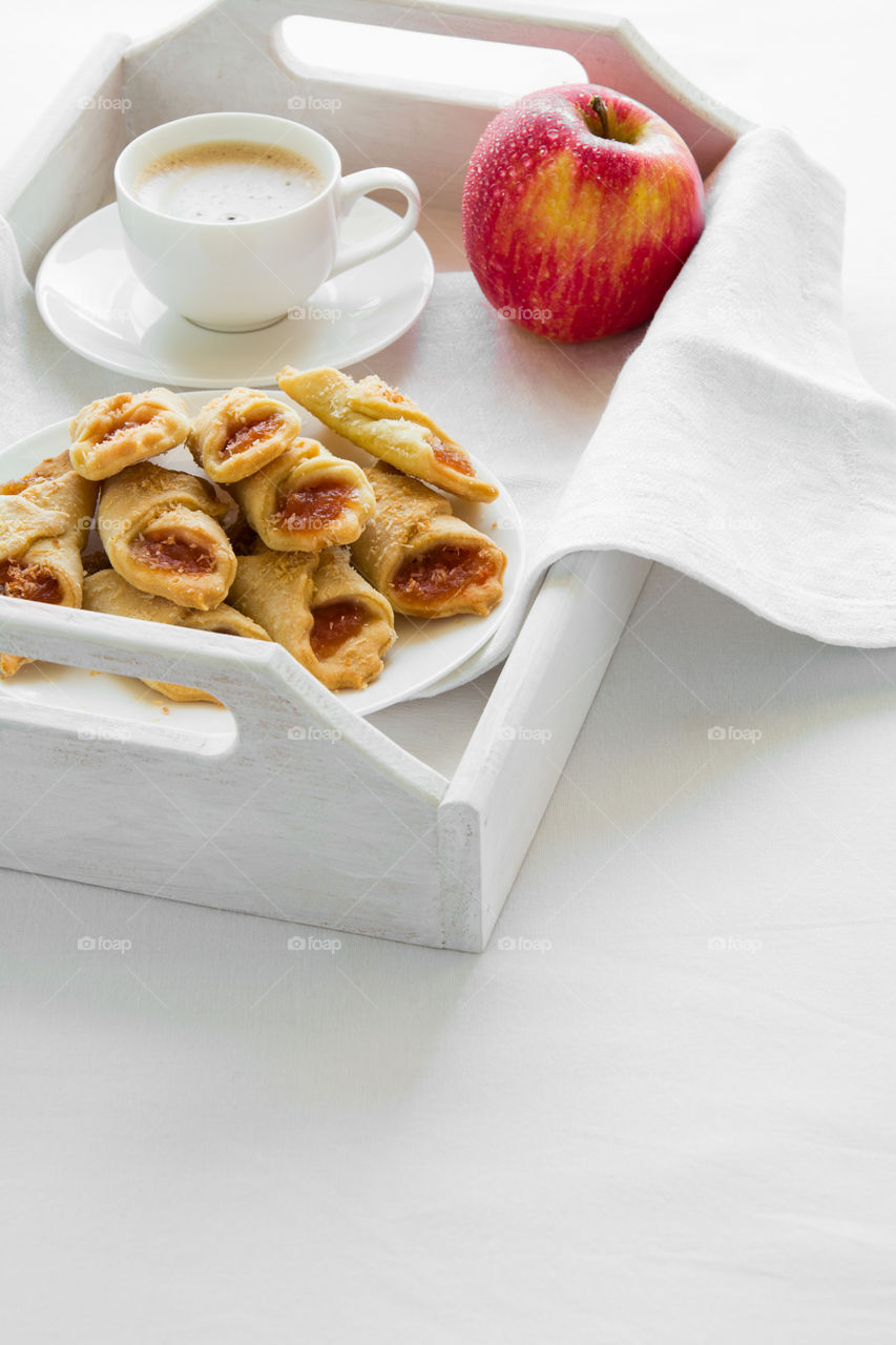 Tea time with Polish cream cheese cookies (Kolacky) with apple jam on white table cloth