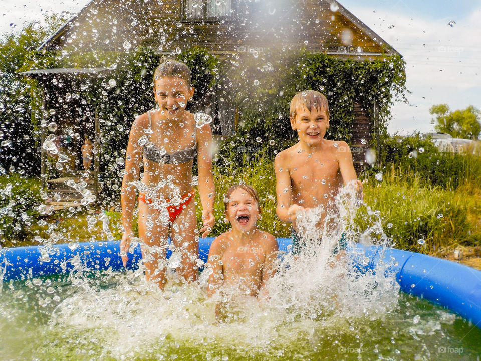 Kids are doing a lot of splashes in the garden pool