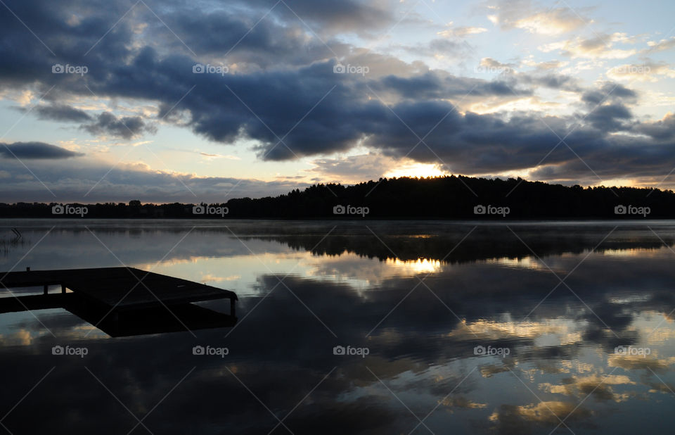 the lake reflection during sunrise time